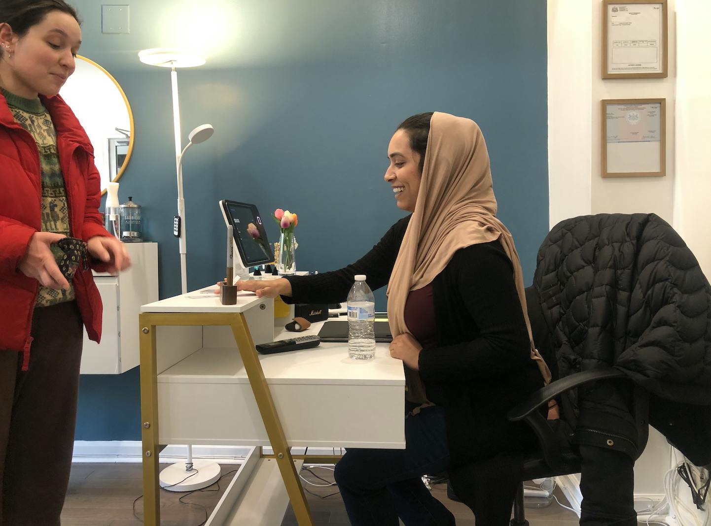 Immigrant entrepreneur Sadia Afreen meets with a customer at the Fishtown shop of the Thread Bar, a business she co-owns with another immigrant businesswoman | Nora Garg/Workshop photographer
