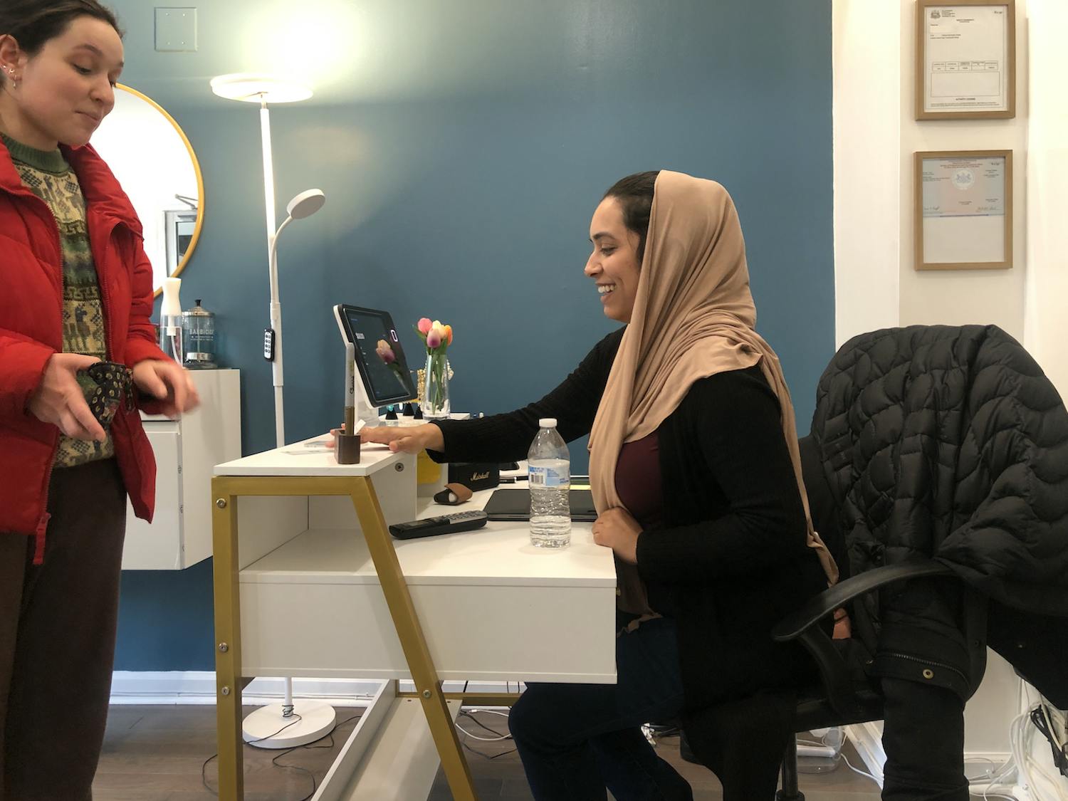 Immigrant entrepreneur Sadia Afreen meets with a customer at the Fishtown shop of the Thread Bar, a business she co-owns with another immigrant businesswoman | Nora Garg/Workshop photographer