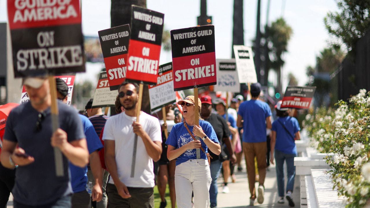 SAG-AFTRA Actors and Writers Guild writers walk the picket line during their strike outside Netflix offices | Courtesy of CNN/Mario Anzuoni