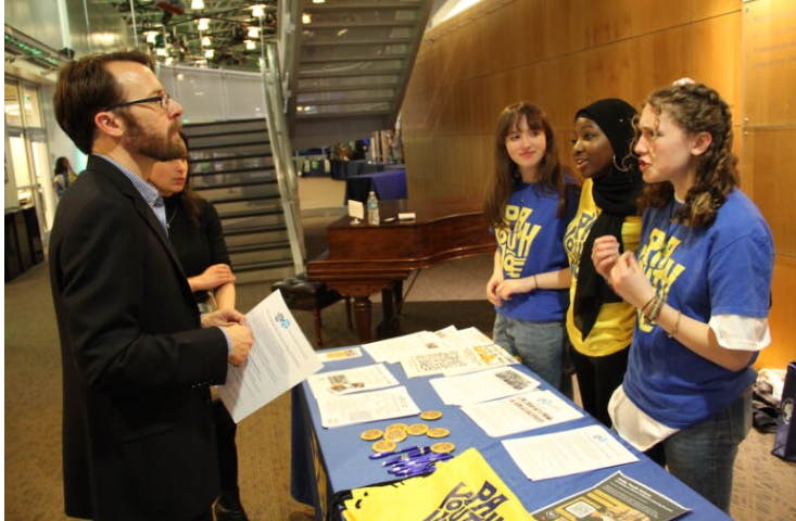 PA Youth Vote student ambassadors Savannah Sandhaus, Neematallah Yusuf, and Samantha Sandhaus (left to right) speaking with local government and media officials about the need for youth civic engagement | Sam Searles, WHYY