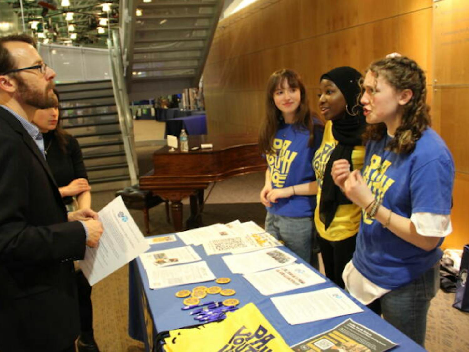 PA Youth Vote student ambassadors Savannah Sandhaus, Neematallah Yusuf, and Samantha Sandhaus (left to right) speaking with local government and media officials about the need for youth civic engagement | Sam Searles, WHYY