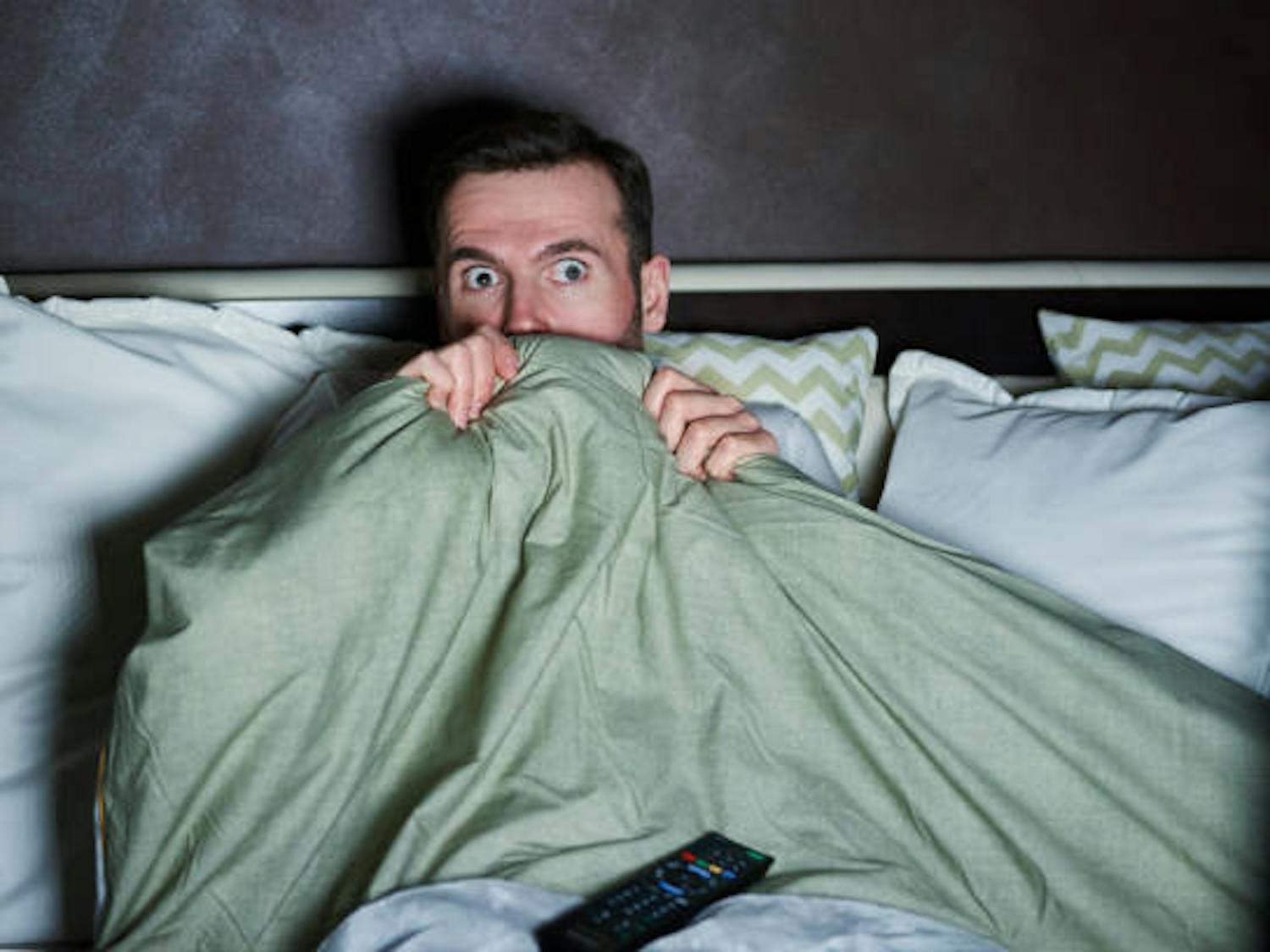 Scared person watching horror movies at night | Source: iStock