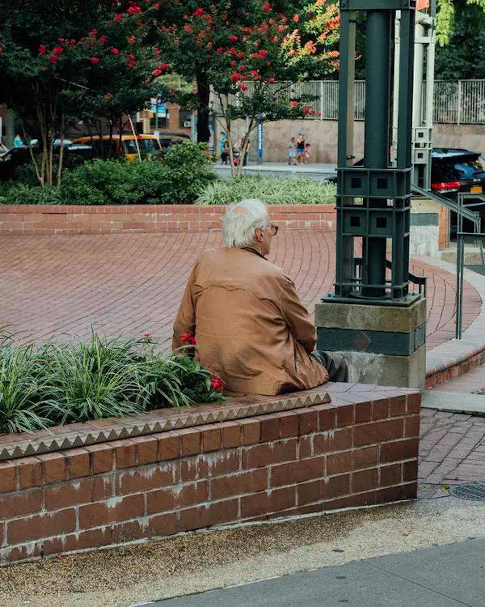 A man taking a rest on a brick bench | Source: The New York Times