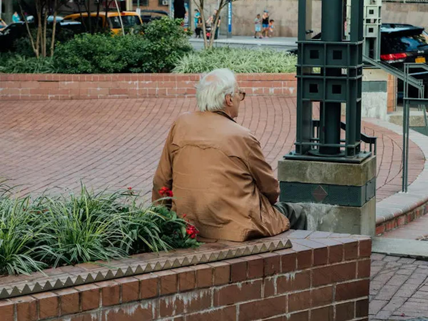A man taking a rest on a brick bench | Source: The New York Times