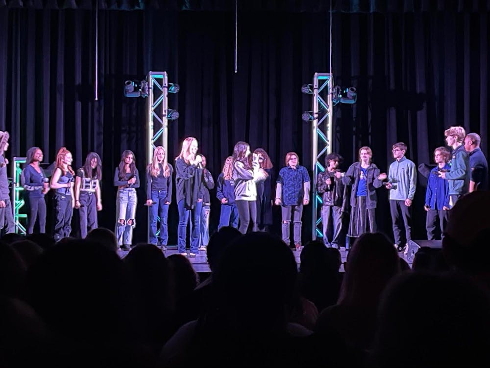 <p>GFS a cappella performing in front of a full auditorium for the annual GFS a cappella invitational fest in February | Source: Germantown Friends School </p><p><br/><br/></p><p></p>