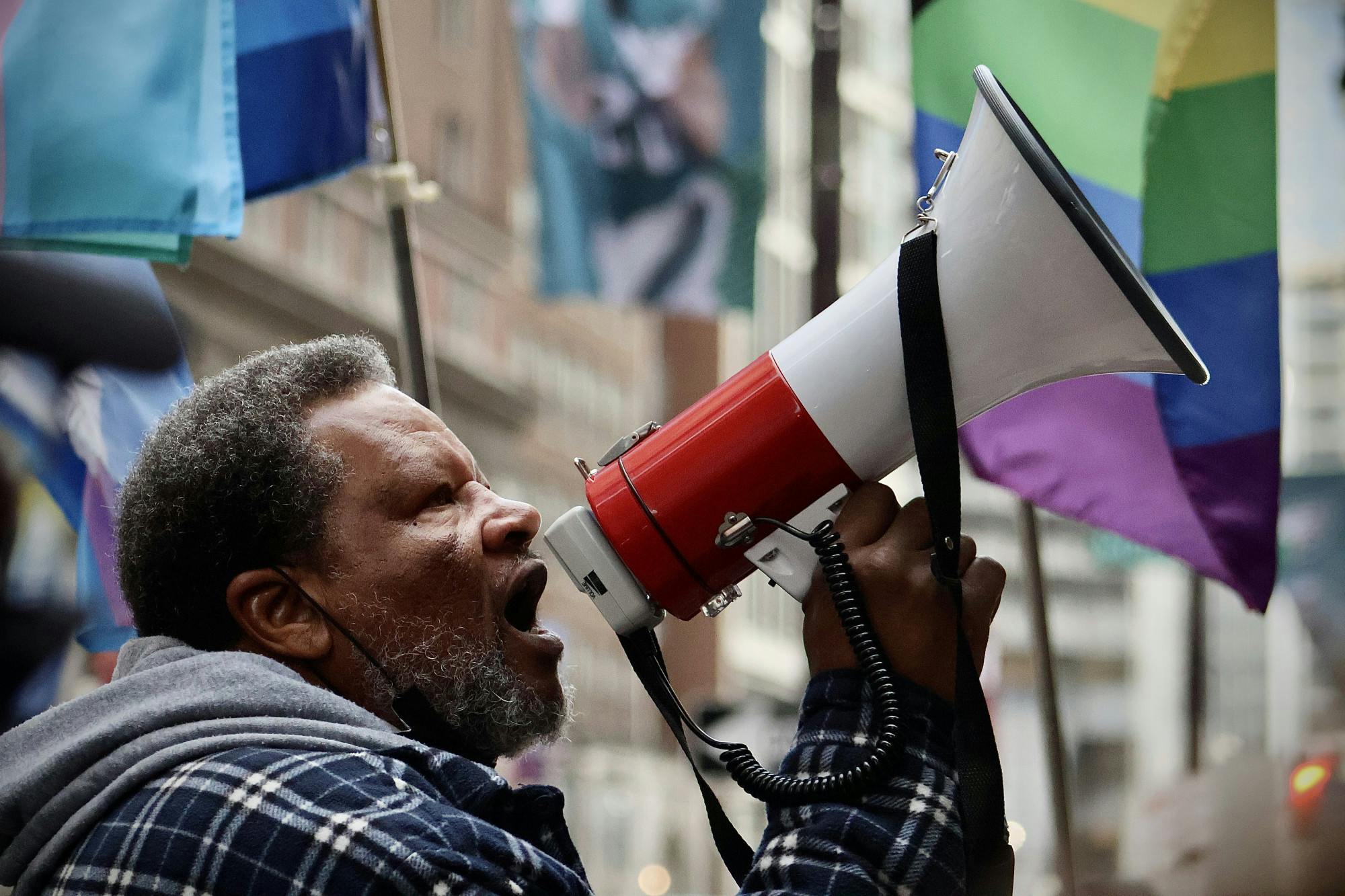 Protestor stood outside of The Union League of Philadelphia as event attendees entered into the building as a megaphone was passed around amongst speakers and other protestors | (Kasey Shamis/Bullhorn Photographer)