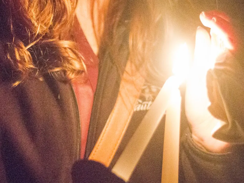 Students light candles at Take Back the Night on Oct. 14 at the Quad. Take Back the Night is a march to spread domestic violence. DN PHOTO ALAINA JAYE HALSEY