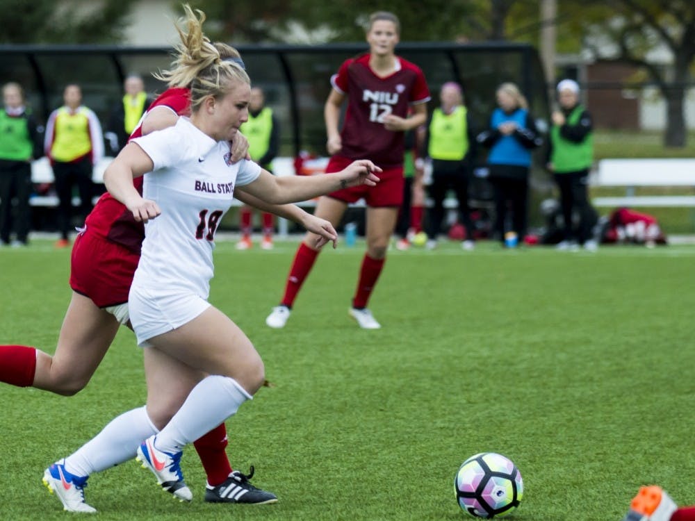 Junior Midfielder Emily Scott attempts to kick the ball away from Northern Illinois University on Oct. 30, 2017 at Briner Sports Complex. Teri Lightning Jr., DN