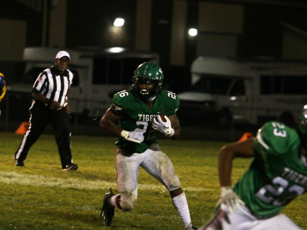 Yorktown senior Ayden Ewing runs with the ball Sep. 29 in a game against Greenfield Central. Zach Carter, DN. 