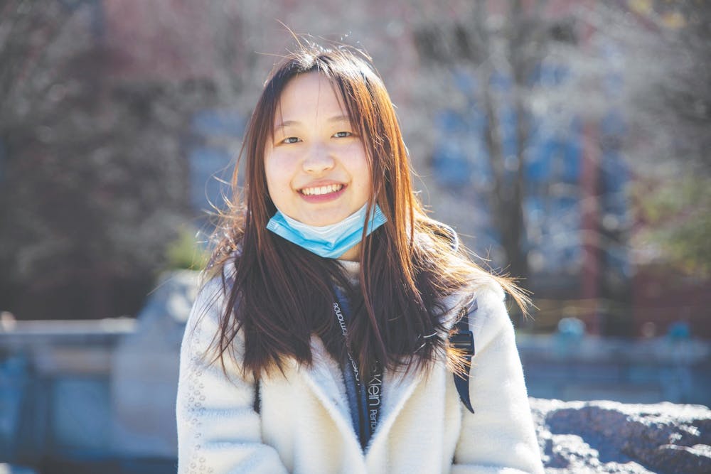 <p>Senior journalism major Shiyi Sun smiles in front of Frog Baby March 2, 2021. Sun will graduate from Ball State in May and has already purchased her plane ticket back home to China. <strong>Jaden Whiteman, DN</strong></p>