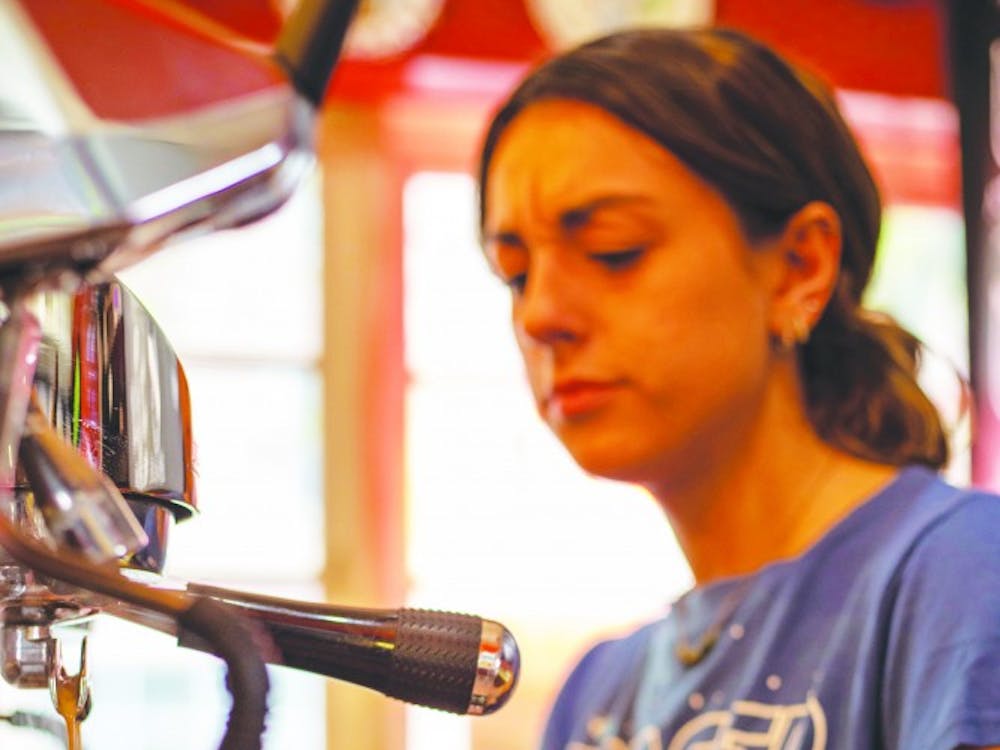 A worker at The Cup makes shots of espresso for a customer’s drink Sept. 8, 2019. The Cup has offered drinks such as smoothies, teas, coffees and more since 2012. Jacob Musselman, DN.