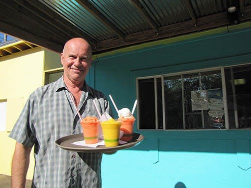 Roger Conatser stands outside Island Muncie, the smoothie stand located behind his home. Conatser, a former photographer, got the idea to open the business catering to people who use the nearby Cardinal Greenway. DN PHOTO SAFARALI SAYDSHOEV