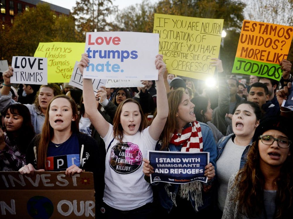 Protesters gather outside the White House after Donald Trump's first visit as president-elect on Thursday, Nov. 10, 2016, in Washington, D.C. (Olivier Douliery/Abaca Press/TNS)