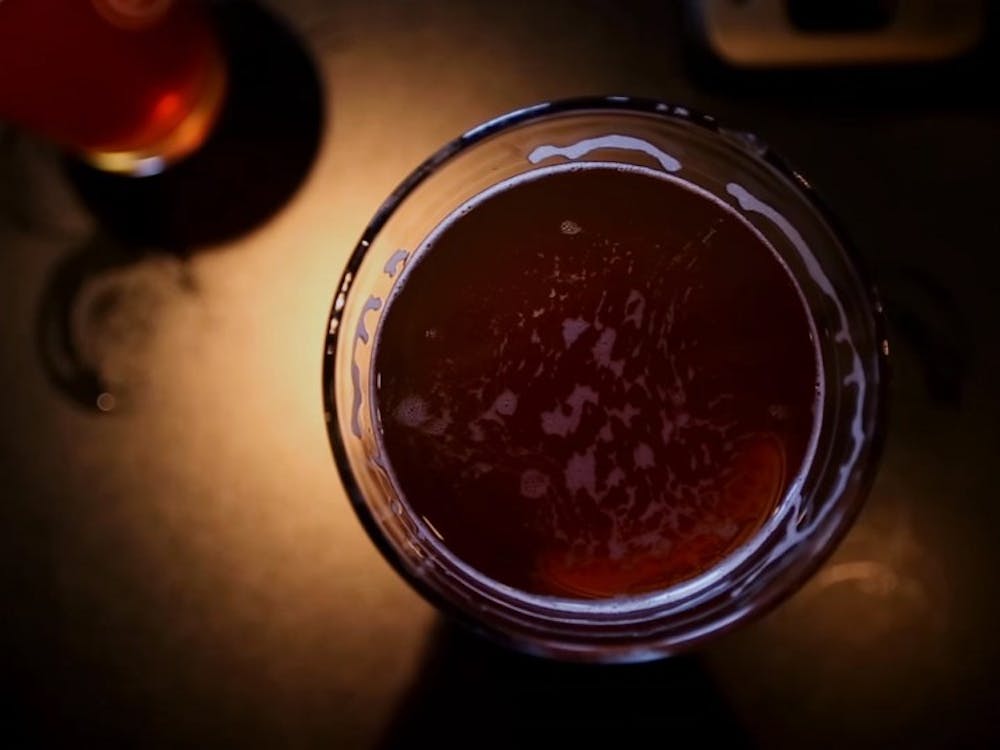 A pint of beer sits on a table at a brewery. Robbie Mehling, a telecommunications graduate student, created 