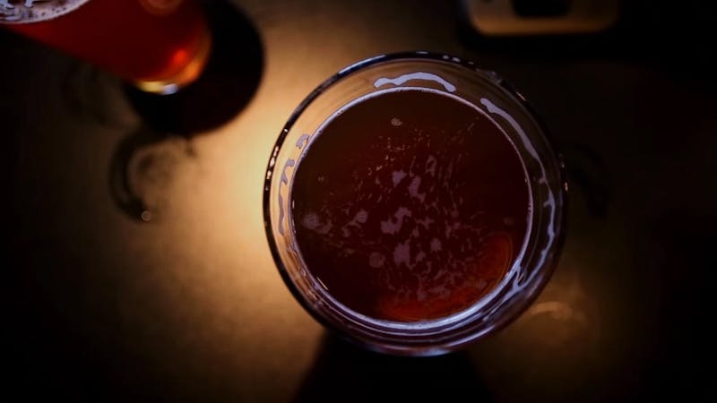 A pint of beer sits on a table at a brewery. Robbie Mehling, a telecommunications graduate student, created 