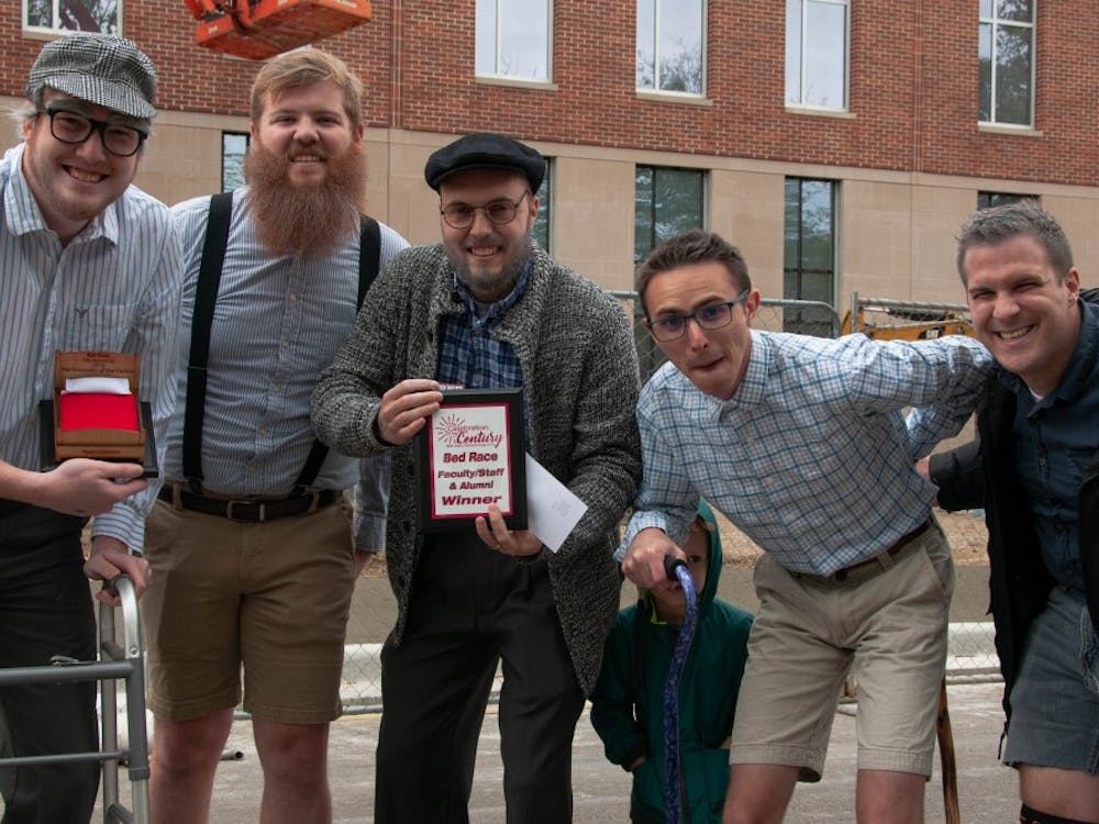 Housing and Residence Life faculty members pose with their plaque after competing in the Bed Race, an annual Homecoming event Oct. 19, 2018, on Riverside Ave. The team earned their title for having the fastest time in the faculty/staff and alumni category. Madeline Grosh,DN