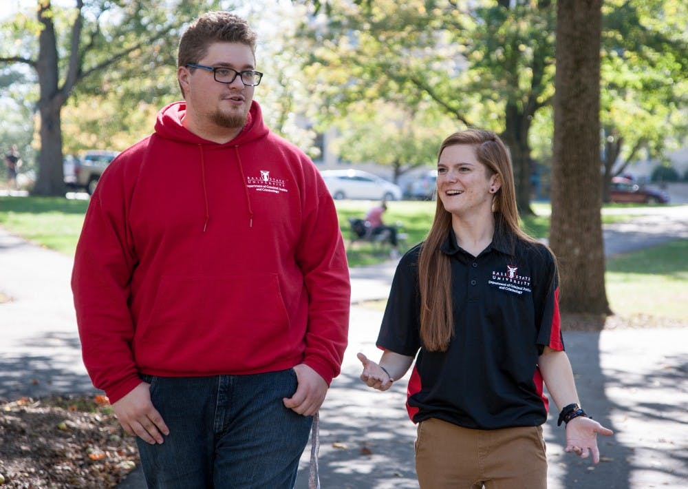 Criminal justice majors Daniel South and Rachel Burns walk through the Quad in their criminal justice clothing. Kaiti Sullivan, DN