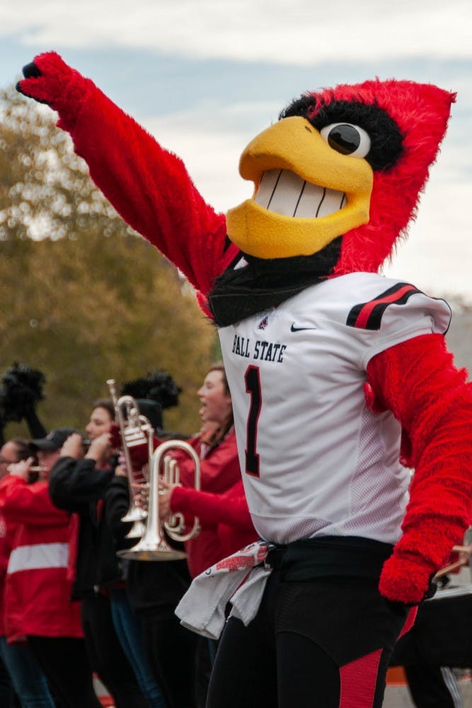 Charlie Cardinal cheers on competing during the annual Homecoming event, Bed Race Oct. 19, 2018, on Riverside Ave. Charlie was the final referee during the races Friday afternoon. Madeline Grosh,DN