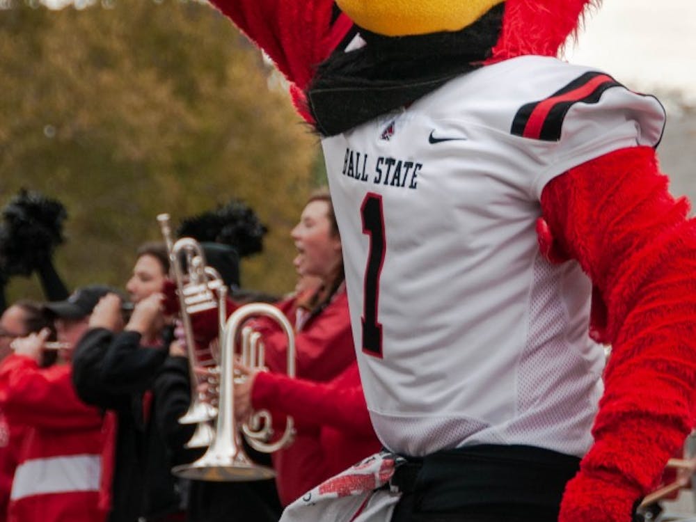 Charlie Cardinal cheers on competing during the annual Homecoming event, Bed Race Oct. 19, 2018, on Riverside Ave. Charlie was the final referee during the races Friday afternoon. Madeline Grosh,DN