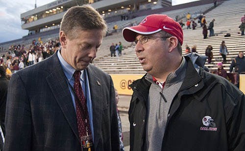 Head coach Pete Lembo speaks to Athletic Director Bill Scholl after the victory over Central Michigan. DN PHOTO BOBBY ELLIS