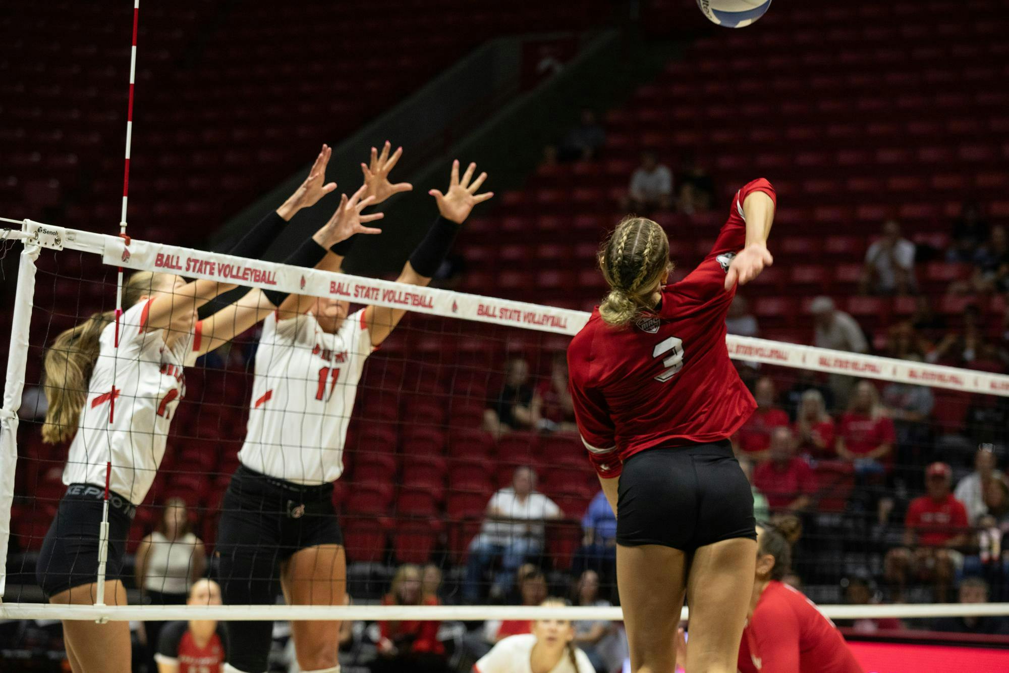 Sophomore middle hitter Tiffany Smook (left) and junior middle hitter Camryn Wise (right) go up for a block Oct. 2 at Worthen Arena. Ball State defeated Northern Illinois 3-0. Kyle Stout, DN
