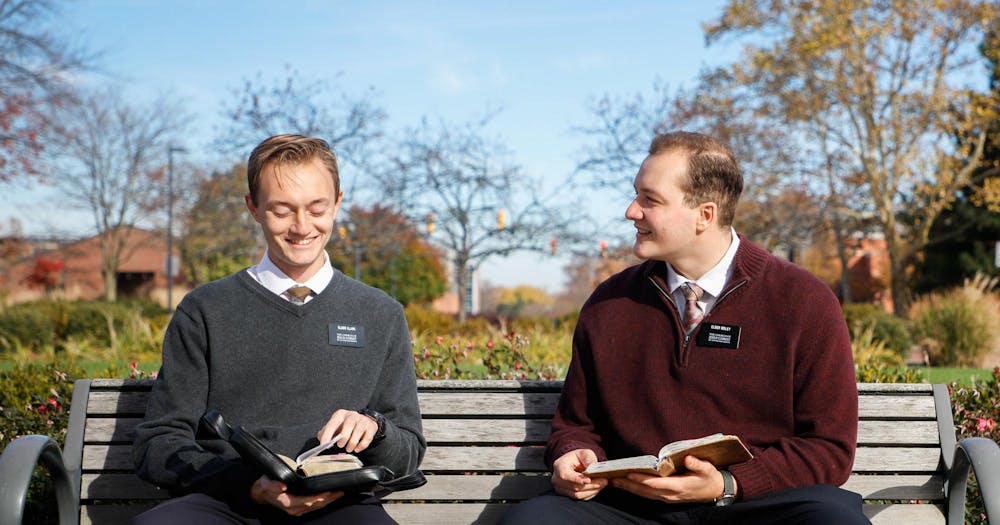 <p>LDS Missionaries Elder Michael Clark and Elder Bobby Seiley sit on a bench Nov. 7 on Ball State Campus Andrew Berger, DN</p>
