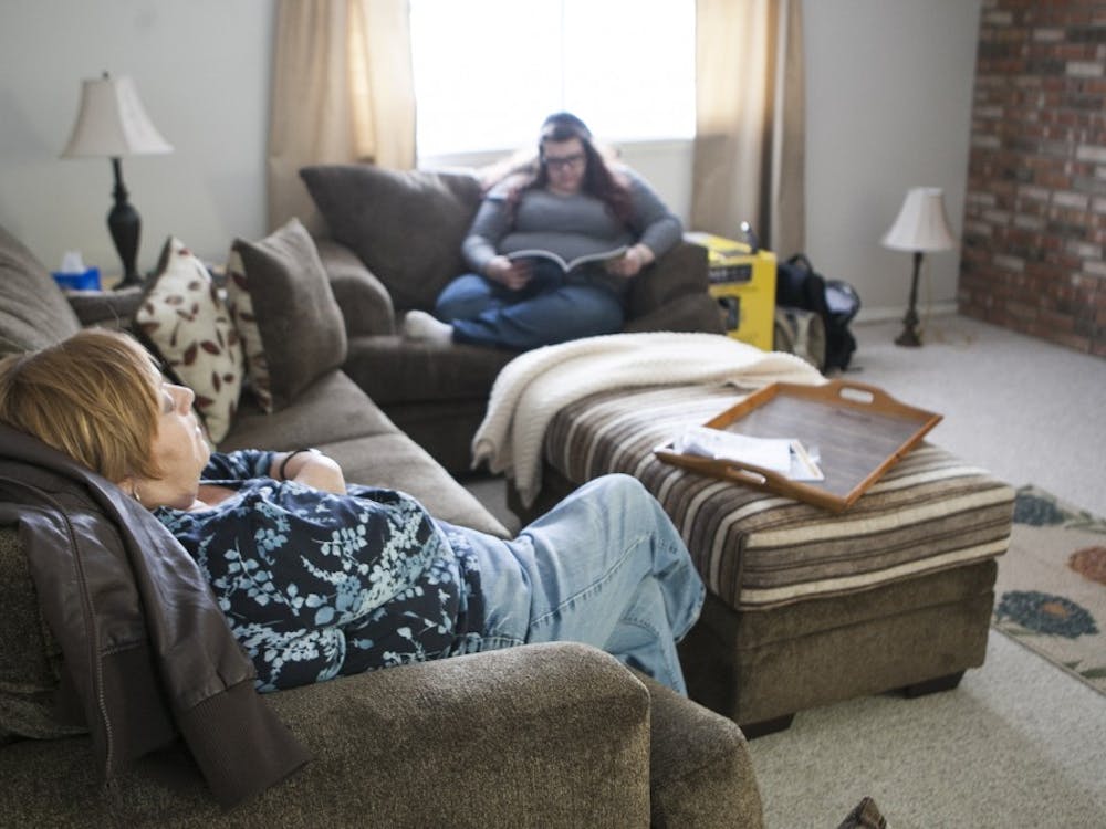 Pam Huffer takes a rest after spending the morning moving into her new home in Muncie in January 2014 after her husband died in September 2013. Huffer passed away Oct. 9, leaving her two daughters Emily and Jordan. DN FILE PHOTO JORDAN HUFFER