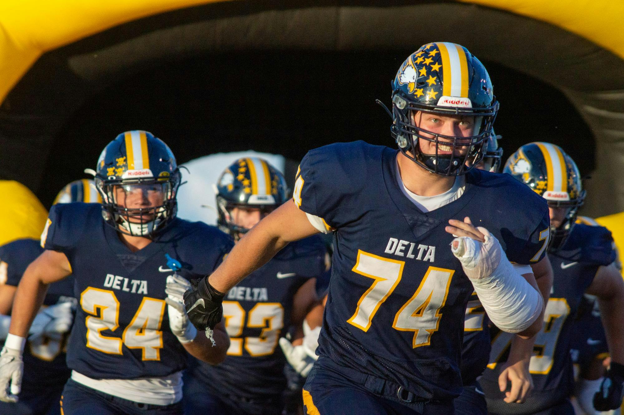 Senior offensive/defensive lineman Corbin King runs out onto the field with Delta before facing Yorktown Sept. 8. The Eagles defeated the Tigers 22-13. Daniel Kehn, DN