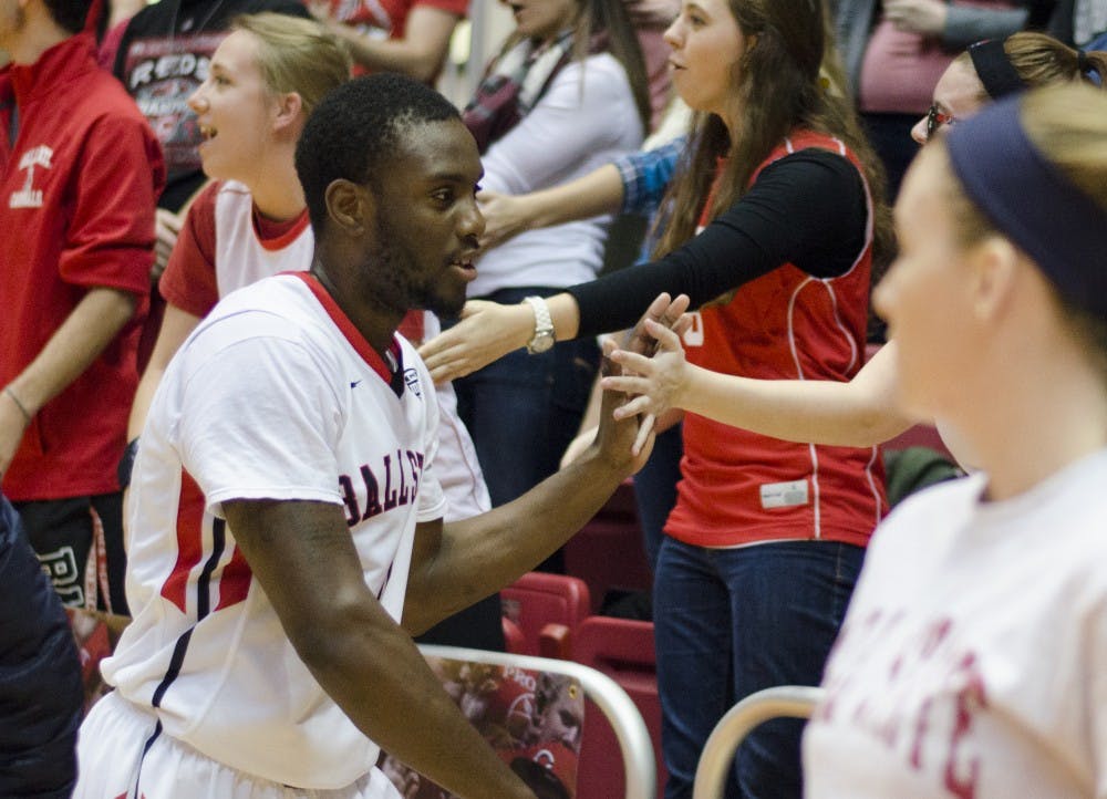 Freshman guard Francis Kiapway high fives members of The Nest after the game against Indiana State on Dec. 6 at Worthen Arena. DN PHOTO BREANNA DAUGHERTY