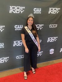 Savannah Boneta, third-year public relations major, poses with her crown and sash in Carmel, Indiana, for the premiere of 100 Days to Indy in early April.