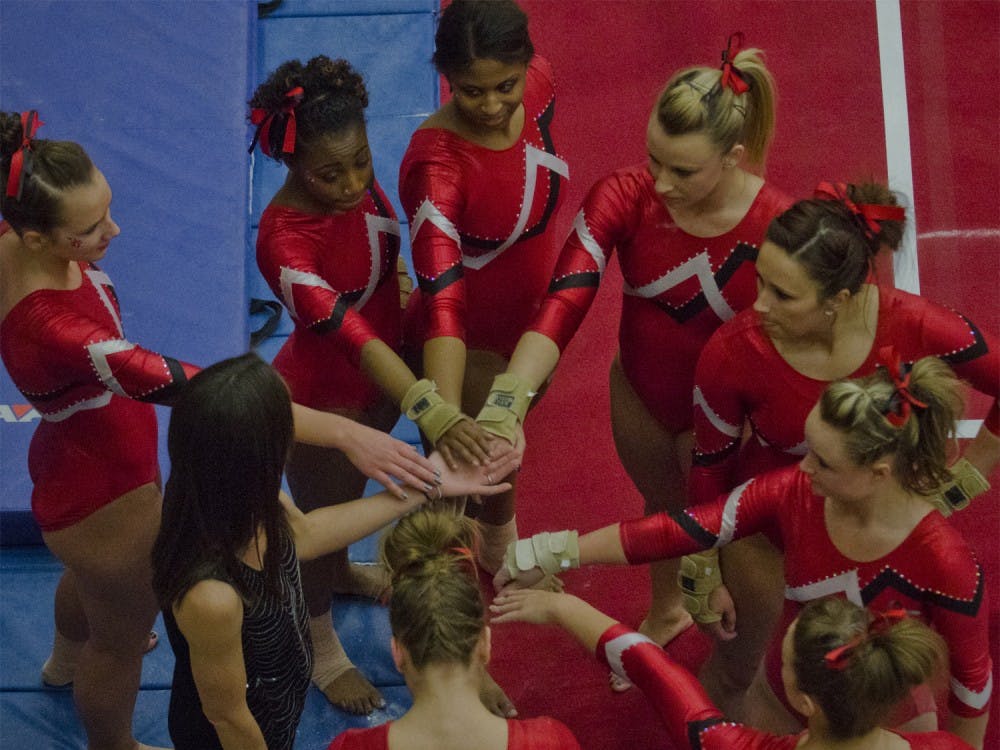 The Ball State women's gymnastics team huddles together before the last event of the competition against Iowa University Jan. 17 at the Ball State Recreation Center. DN PHOTO MARCEY BURTON 