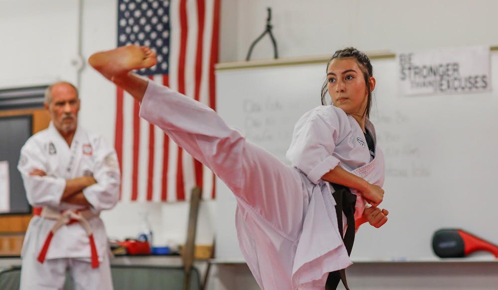 Delta freshman Addison Childers practices high kicks Oct. 8 at Shirokai Martial Arts Dojo. Despite opportunities to pursue many other sports at Delta, karate was always something that piqued Childers’ interest. Andrew Berger, DN 
