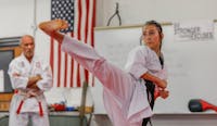 Delta freshman Addison Childers practices high kicks Oct. 8 at Shirokai Martial Arts Dojo. Despite opportunities to pursue many other sports at Delta, karate was always something that piqued Childers’ interest. Andrew Berger, DN 
