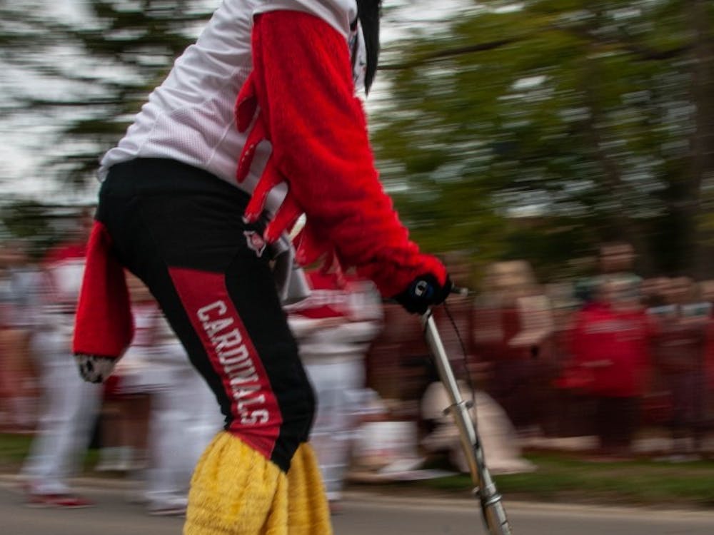 Charlie Cardinal races down Riverside Ave. on a scooter during downtime inbetween races at the annual Homecoming event, Bed Race Oct. 19, 2018, on Ball State's campus. Charlie was the final referee during the races Friday afternoon. Madeline Grosh,DN