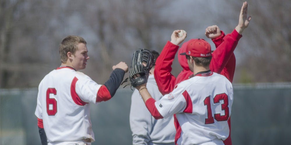 Freshman infielder Alex Maloney celebrates with sophomore outfielder Cole Griesinger after an inning in the game against Eastern Michigan on April 5 at Ball Diamond. DN PHOTO BREANNA DAUGHERTY 