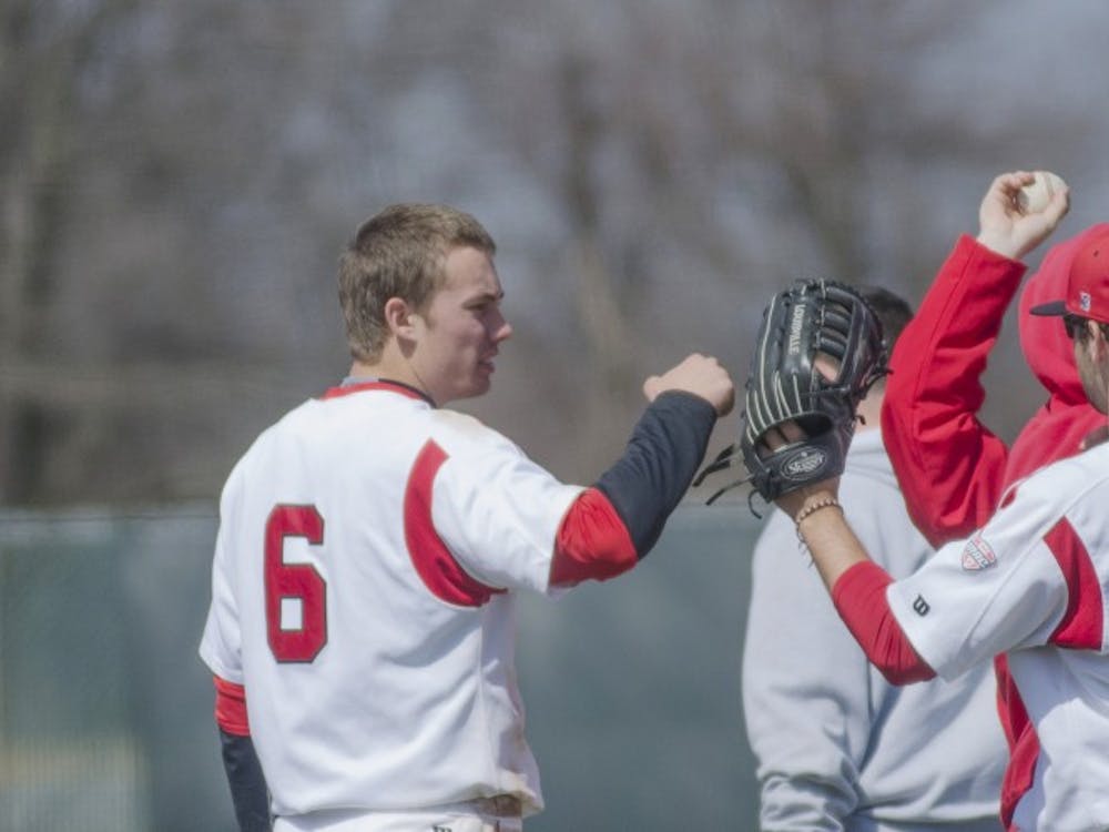 Freshman infielder Alex Maloney celebrates with sophomore outfielder Cole Griesinger after an inning in the game against Eastern Michigan on April 5 at Ball Diamond. DN PHOTO BREANNA DAUGHERTY 