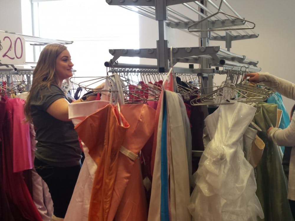 Jillian Hooper and Emily Wade, members of Ball State's Fashion Merchandising Association, browse through dresses donated for FMA's Cinderella's Closet event. The annual event provides discounted prom dresses to high school students. DN PHOTO TRISTAN BENNINGTON