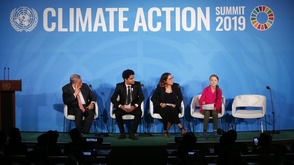 United Nations Secretary-General Antonio Guterres, far left, and young environmental activists look on as Greta Thunberg, of Sweden, far right, addresses the Climate Action Summit in the United Nations General Assembly, at U.N. headquarters, Monday, Sept. 23, 2019. (AP Photo/Jason DeCrow)