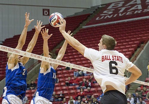 Greg Herceg tips the ball over the net into IPFW territory. Herceg had 8 total kills against IPFW. DN PHOTO COREY OHLENKAMP