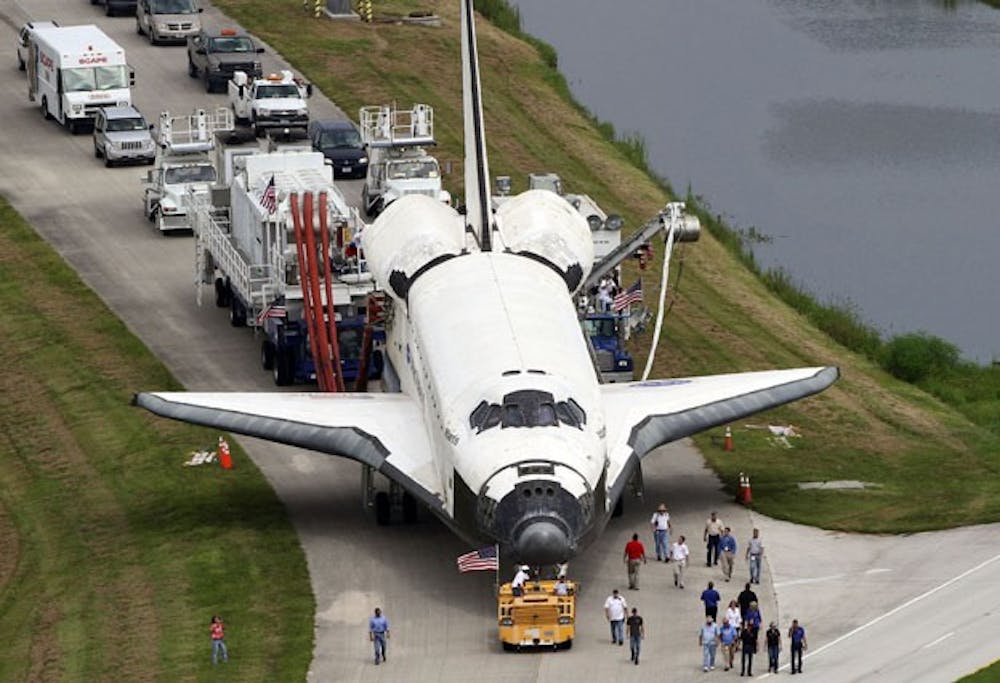 Space shuttle Atlantis, STS-135, is towed to a Oribitor Processing Facility at Kennedy Space Center in Florida, after landing Thursday, July 21, 2011, concluding 30 years and 135 missions. (Red Huber/Orlando Sentinel/MCT)