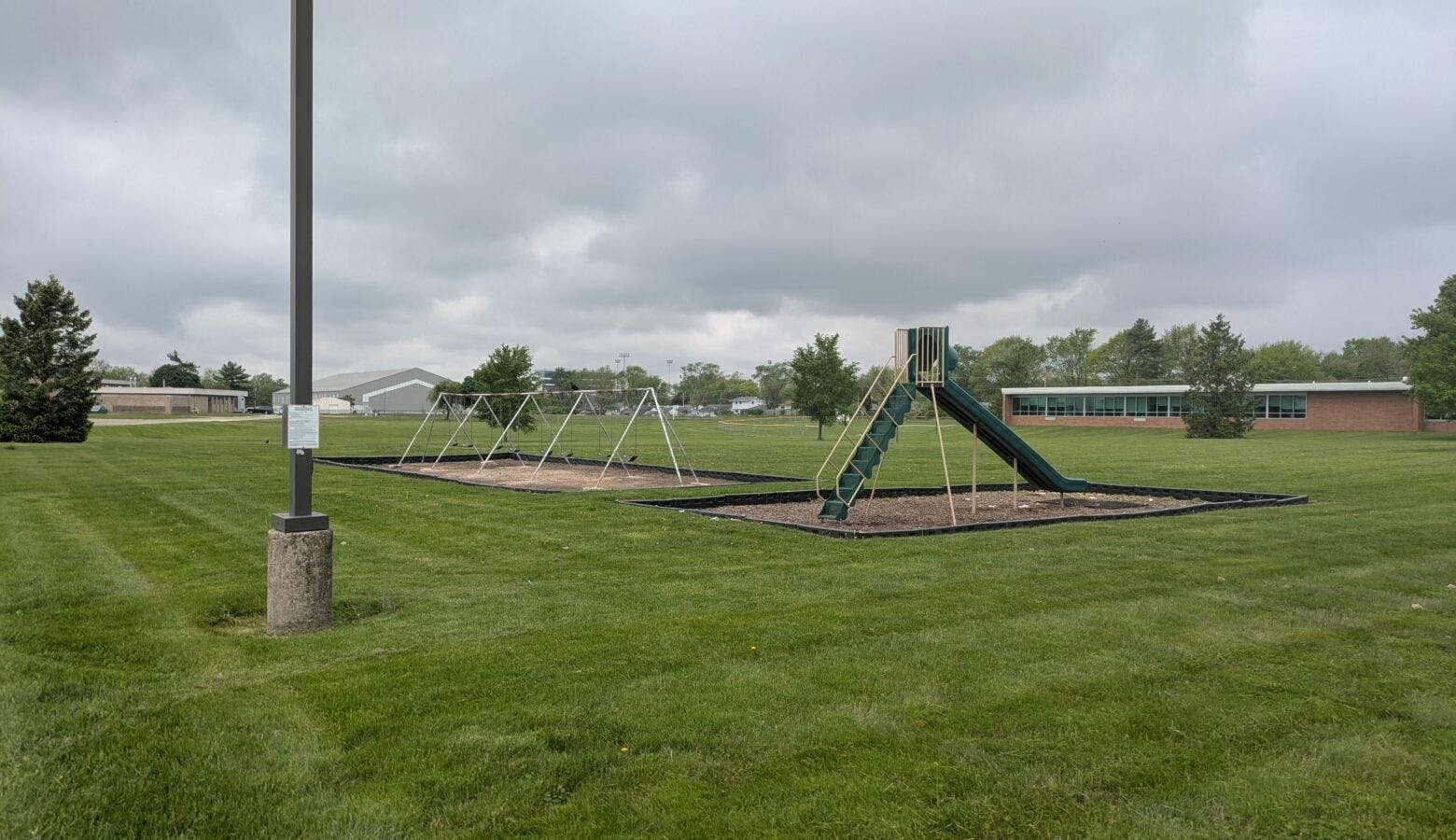 Swings and a slide already sit outside the Ball State Oakwood Building. (Stephanie Wiechmann / IPR News)