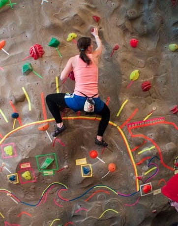 Then-sophomore Victoria Roser climbs Boulder Ball April 12, 2013. Boulder Ball is hosted at the Student Recreation and Wellness Center's rock wall and is one of many events that take place at the facility. DN FILE PHOTO BOBBY ELLIS