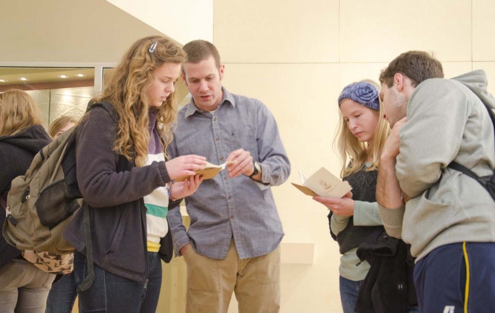 Laura Lemna, Becky Diener and Ryan Noll discuss the Echoes of an Object art exhibit in the Atrium Gallery with featured artist and assistant professor David Hannon on Friday. The exhibit runs until De. 1. DN PHOTO COREY OHLENKAMP