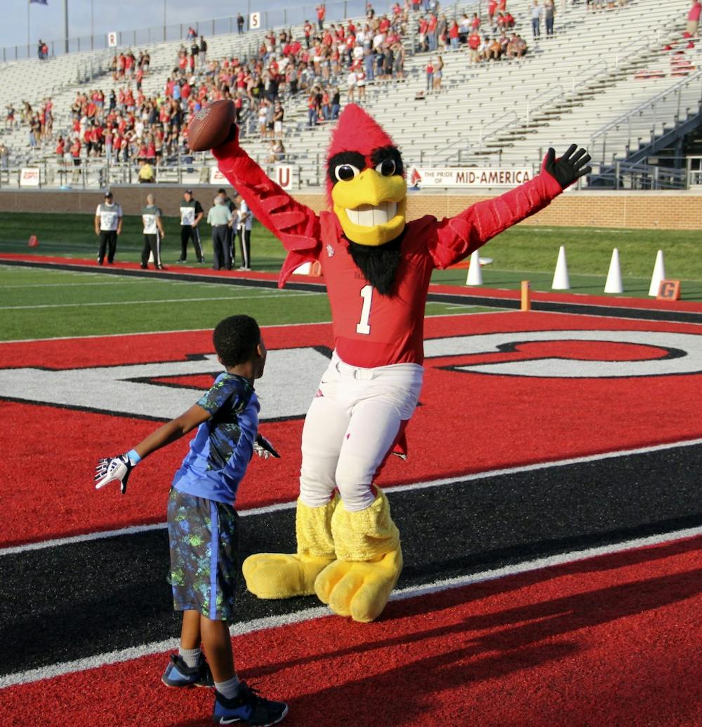 Charlie Cardinal plays football with a young Ball State fan before the Cardinals' game against Central Connecticut State Thursday, Aug. 31, 2018 at Scheumann Stadium. Charlie Cardinal is Ball State's Mascot. Paige Grider, DN