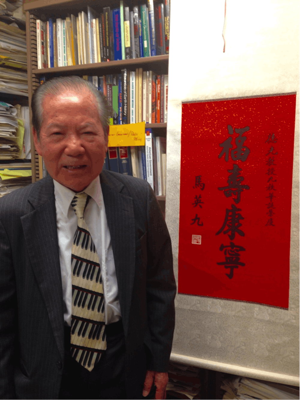 <p>Teh-Kuang Chang, professor of political science, stands in front of a scroll given to by Ma Ying-jeou, the president of the Republic of China in honor of Chang's 90th birthday. Chang has worked at Ball State since 1966 and traveled to over 70 countries. <em>DN PHOTO DEJA STUDDARD</em> </p>