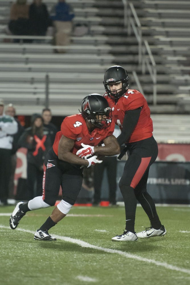 Freshman quarterback Jack Milas hands off the ball to junior running back Horactio Banks during the game against Northern Illinois on Nov. 5 at Scheumann Stadium. DN PHOTO JONATHAN MIKSANEK