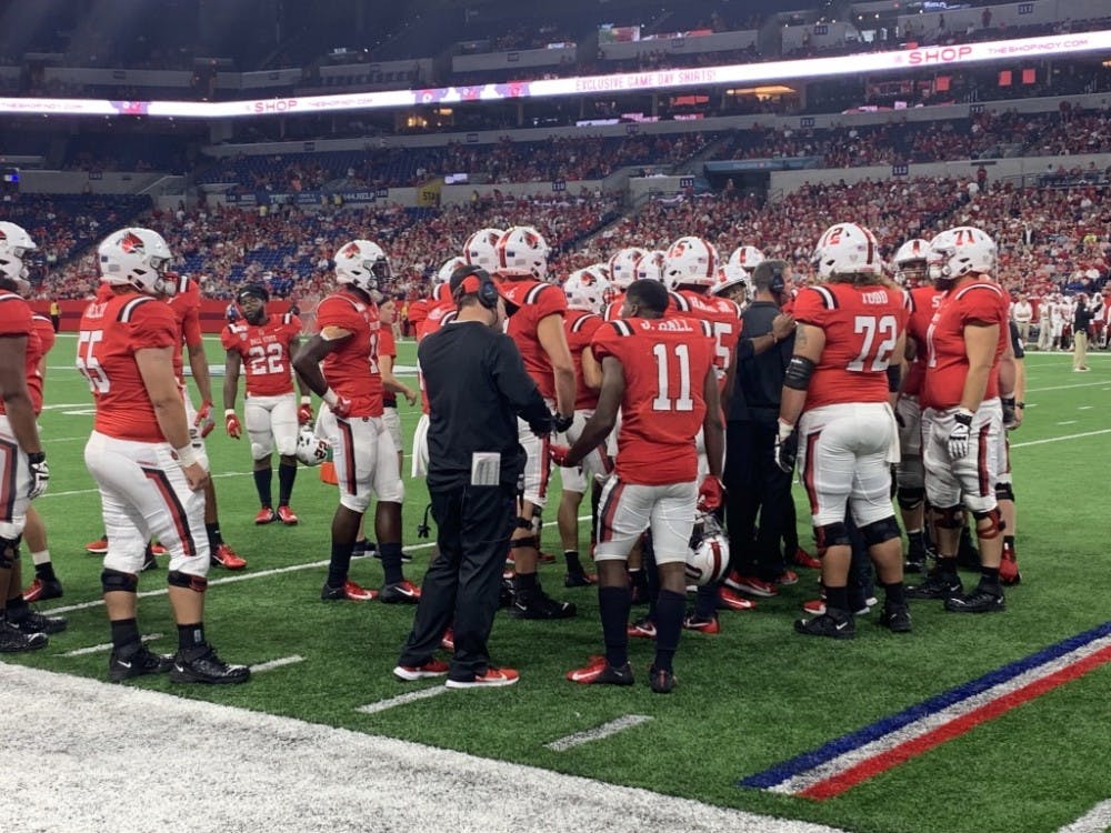 Ball State's football team huddles together during a time-out to discuss strategies during the 2019 Ruoff Kickoff Classic against Indiana University.