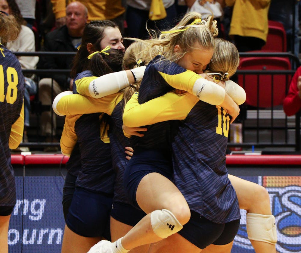 <p>Trinity Lutheran volleyball players embrace each other Nov. 9 after winning the IHSAA 1A State Championship title at Worthen Arena. It's the first state title in any sport for the school. Zach Carter, DN</p>