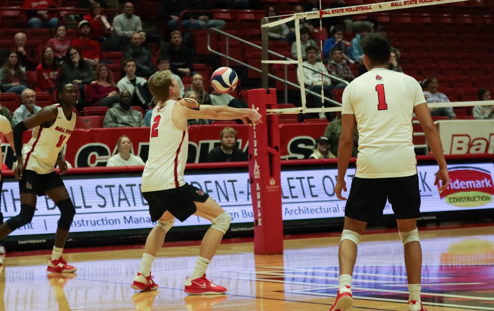 Graduate student outside hitter Kaleb Jenness bumps the ball while second-year outside hitter Tinaishe Ndavazochev and fourth-year senior setter David Flores prepare for the set during a game against Lewis University Feb. 9 at Worthen Arena. Jenness had one recorded dig during the game. Eve Green, DN