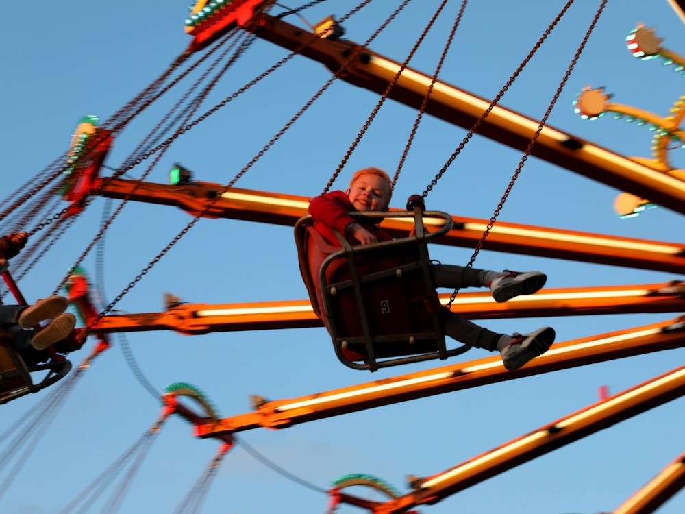 Kavion Riley rides a swing ride April 15, 2021, at the Muncie Mall Spring Fair. The fair is sponsored by Indiana-based company, Jessop Amusements. Rylan Capper, DN